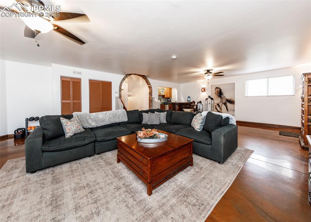 Image 28 of 50: Living room with a ceiling fan