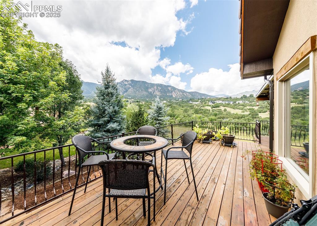 Image 49 of 50: Wooden deck featuring an outdoor fire pit, a mountain view, and view of sca