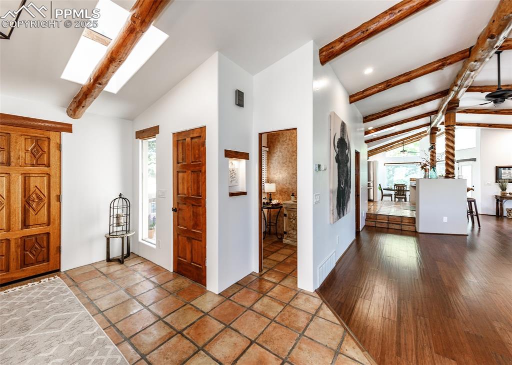 Image 5 of 50: Entrance foyer with a skylight and a ceiling fan