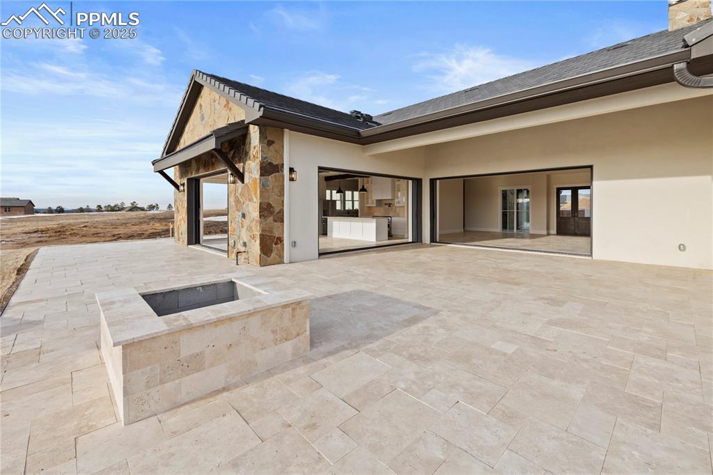 Image 10 of 47: View of patio / terrace with an outdoor fire pit
