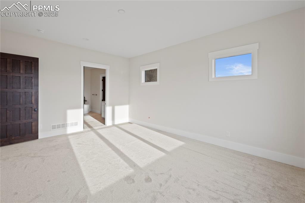 Image 34 of 47: Unfurnished bedroom with carpet floors, baseboards, and visible vents