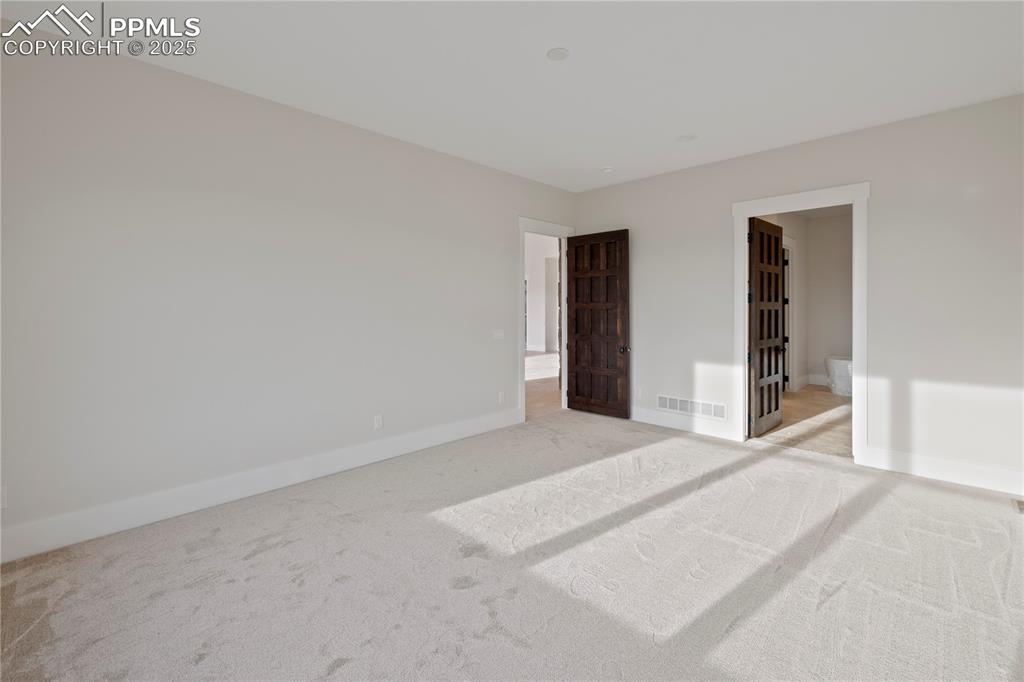 Image 35 of 47: Unfurnished bedroom with light carpet, baseboards, and visible vents