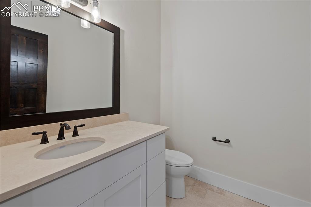 Image 43 of 47: Bathroom featuring baseboards, toilet, and vanity