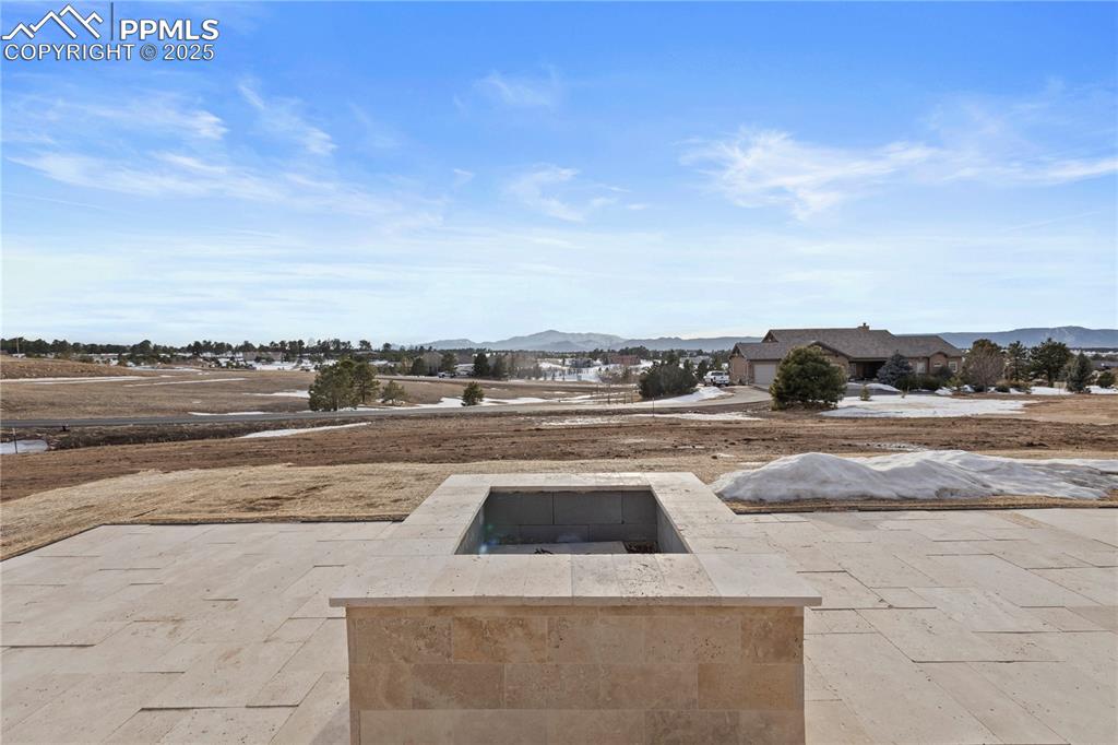 Image 46 of 47: View of patio with a fire pit and a mountain view