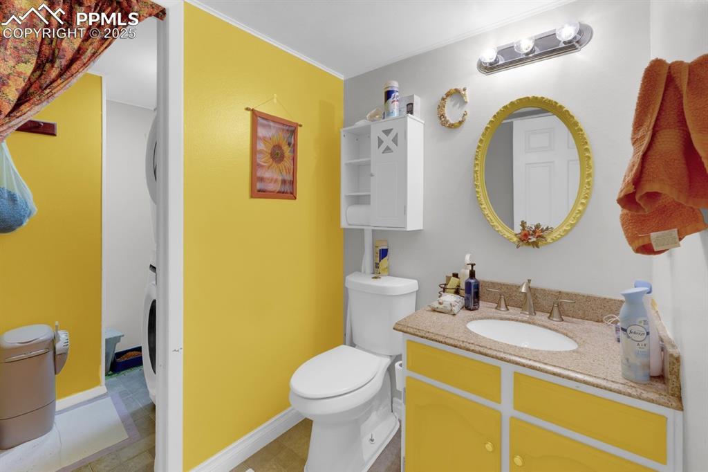 Image 12 of 27: Main Level Half Bath and Laundry Space