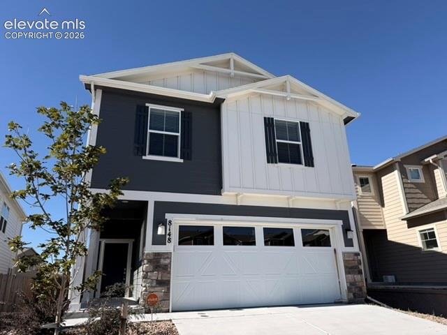 Image 1 of 42: Exterior featuring a two-tone facade, attached garage, stone accents, and d