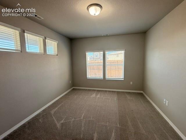 Image 13 of 42: Carpeted interior with neutral wall tones and multiple windows with blinds