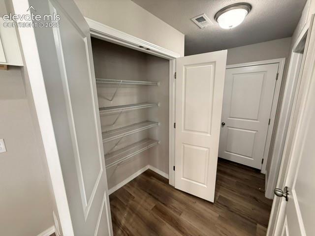 Image 18 of 42: Closet with wire shelving, wood-finish flooring, and white trim