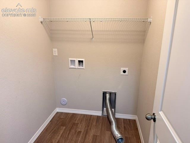 Image 19 of 42: Dedicated utility space featuring wood-finish flooring, light neutral wall