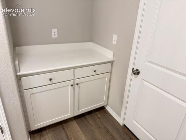 Image 21 of 42: Built-in white cabinetry with a solid surface countertop, two drawers, and 