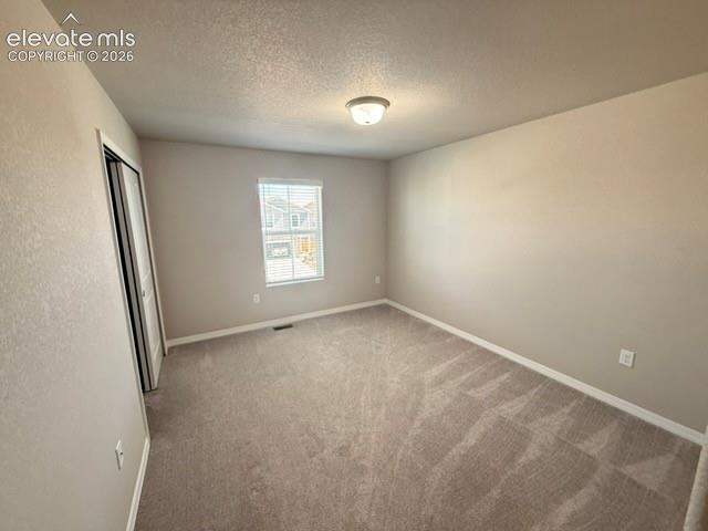 Image 28 of 42: Neutral-toned carpeting, single window with blinds, overhead flush mount li