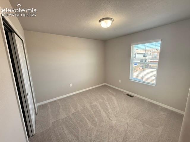 Image 30 of 42: Neutral-toned walls complement the light-colored carpet flooring