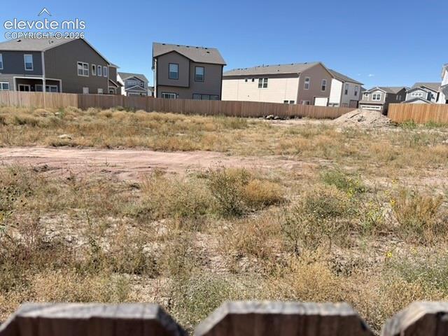 Image 37 of 42: Expansive undeveloped land featuring a partial wood fence