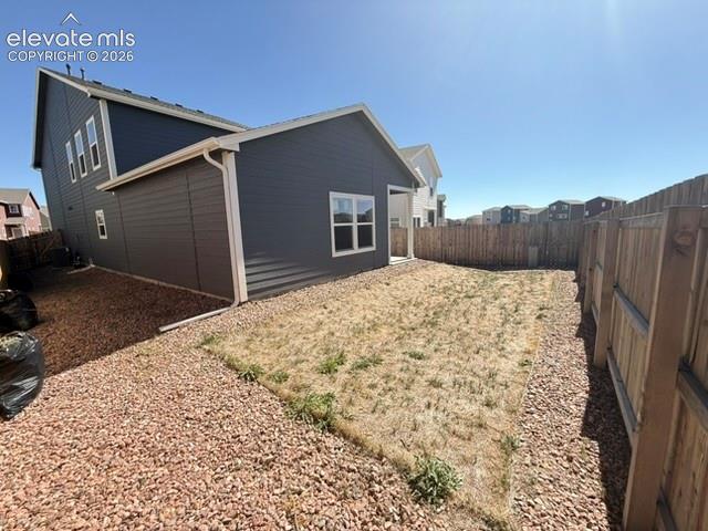 Image 40 of 42: Exterior featuring horizontal siding, white trim, and a fenced perimeter