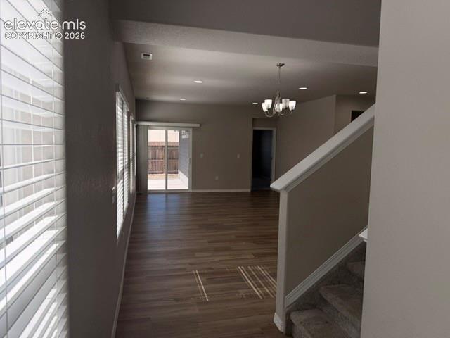 Image 5 of 42: Wood-finish flooring, recessed lighting, chandelier, sliding glass door, an