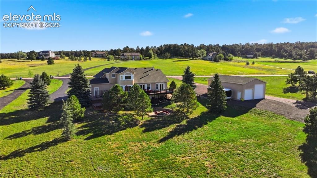 Image 3 of 36: Expansive property featuring a multi-story residence, separate detached gar