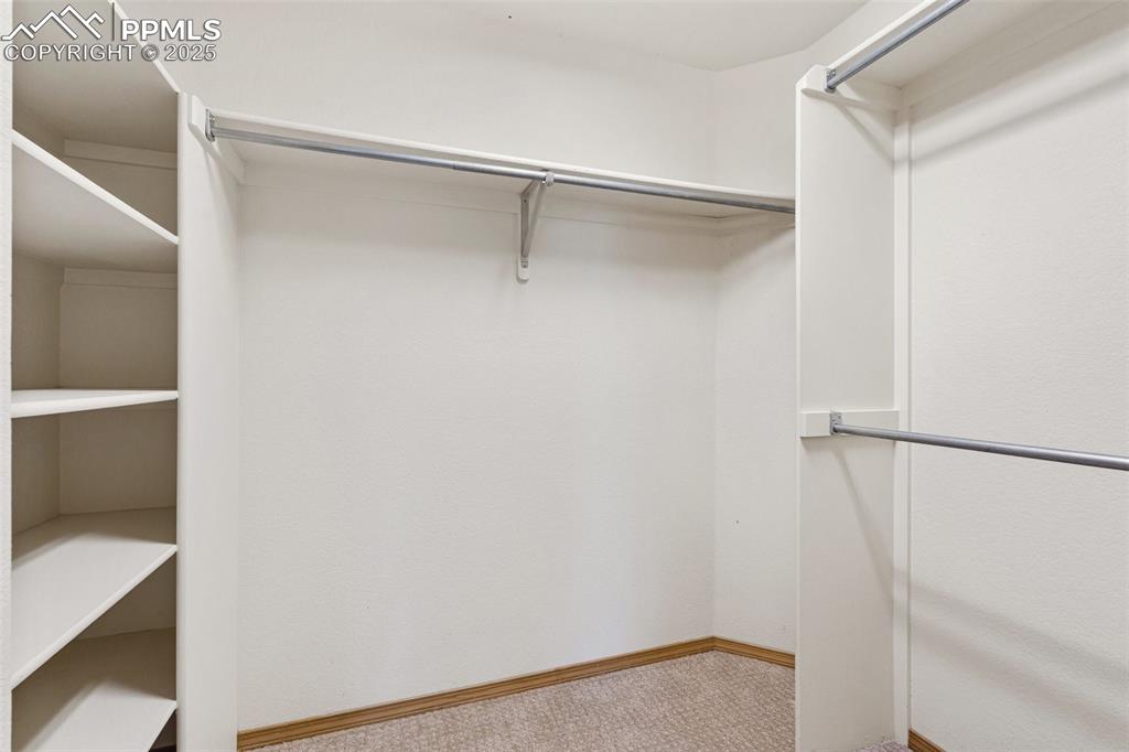 Image 20 of 48: Walk in closet with carpet