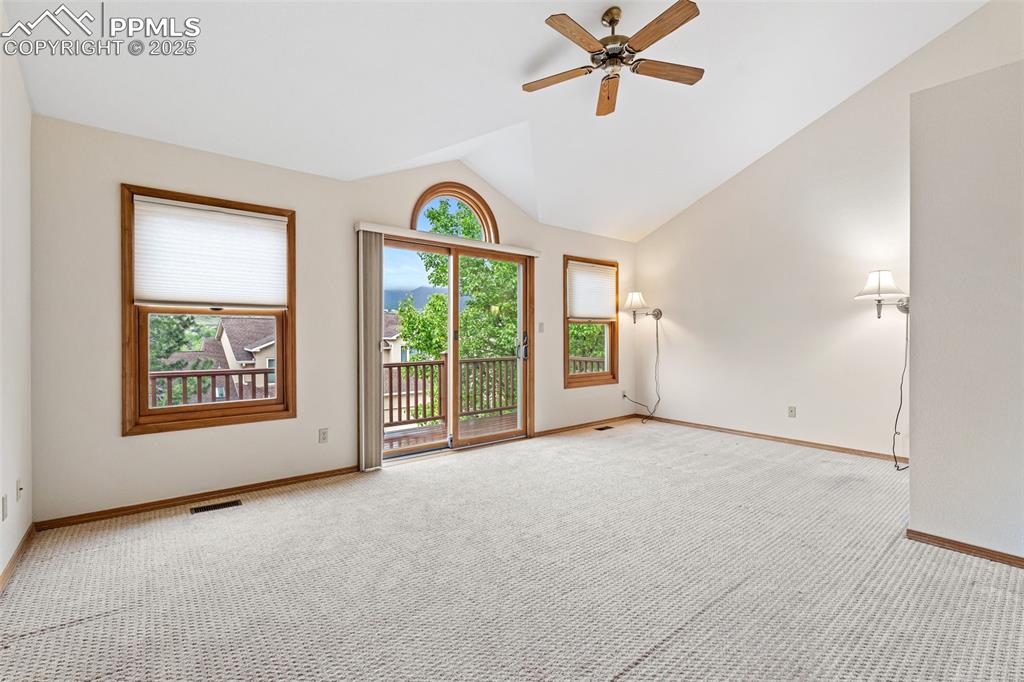 Image 29 of 48: Spare room featuring carpet floors, lofted ceiling, baseboards, and ceiling