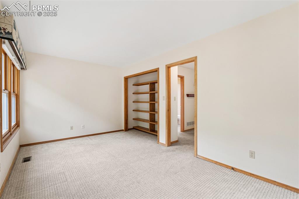 Image 33 of 48: Empty room with carpet flooring and baseboards