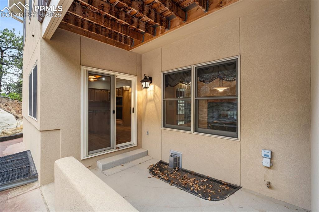 Image 37 of 48: Doorway to property featuring stucco siding