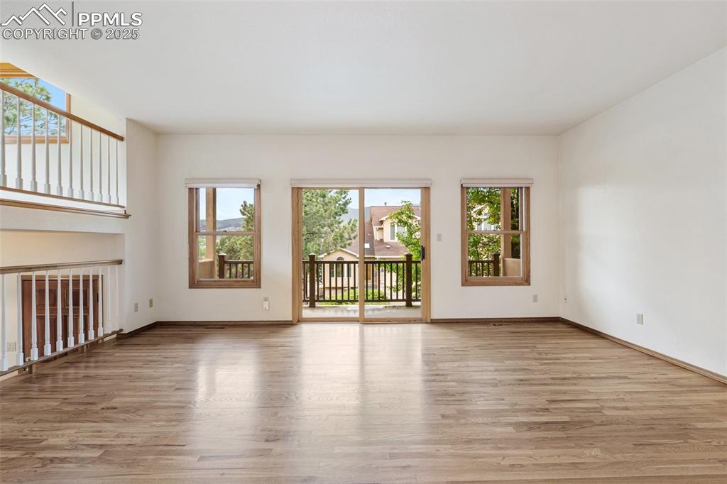Image 4 of 48: Unfurnished living room featuring wood finished floors and baseboards