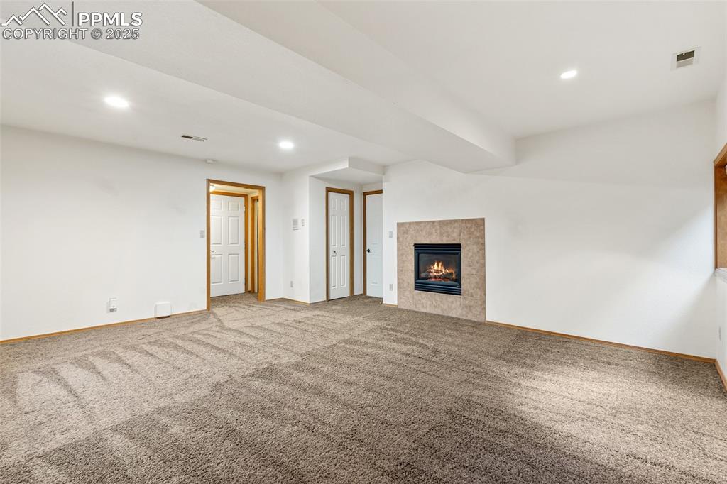 Image 41 of 48: Unfurnished living room featuring baseboards, carpet, recessed lighting, an