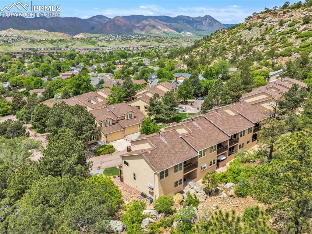 Image 45 of 48: Aerial view of property and surrounding area with a mountainous background
