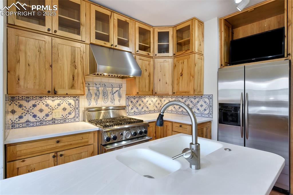 Image 15 of 42: Portuguese tiles over stove add a whimsical touch!