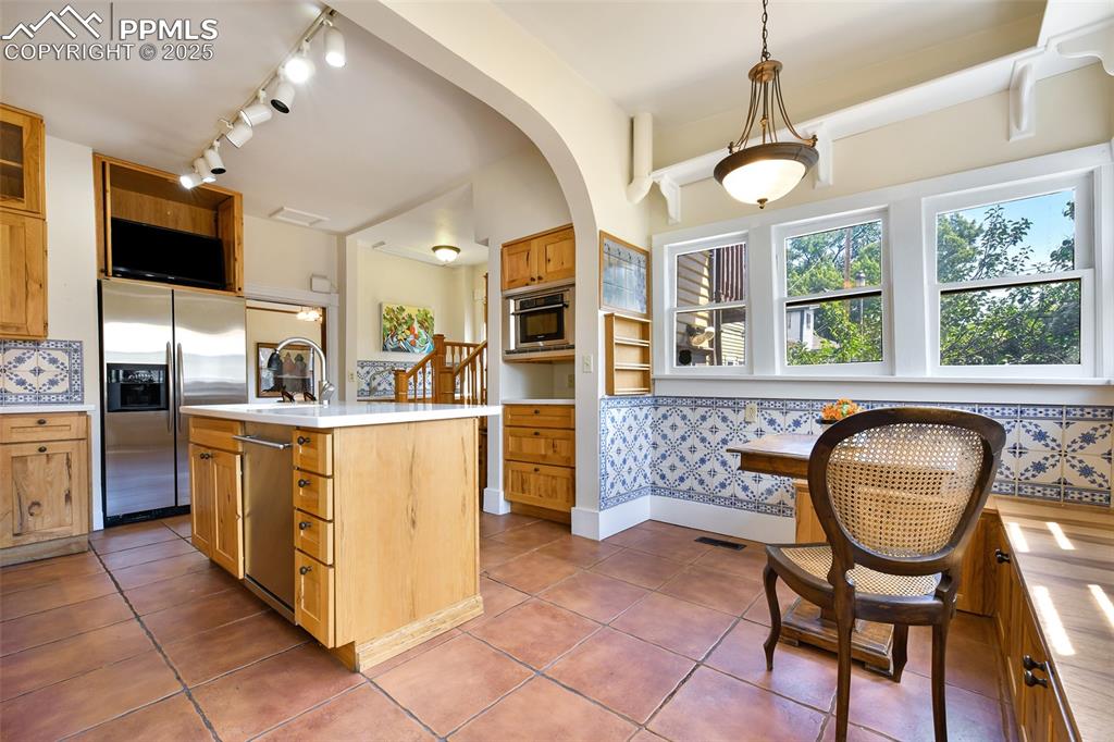 Image 17 of 42: Saltillo tile flooring brings sophistication to this gourmet kitchen