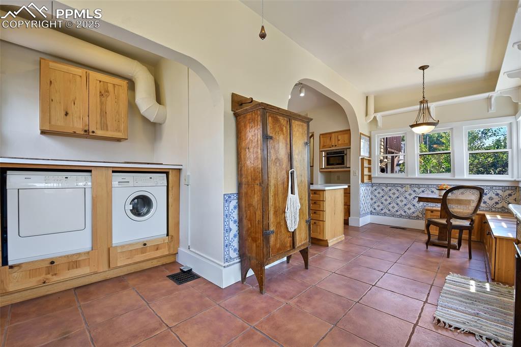 Image 18 of 42: Built in washer and dryer stay with the home