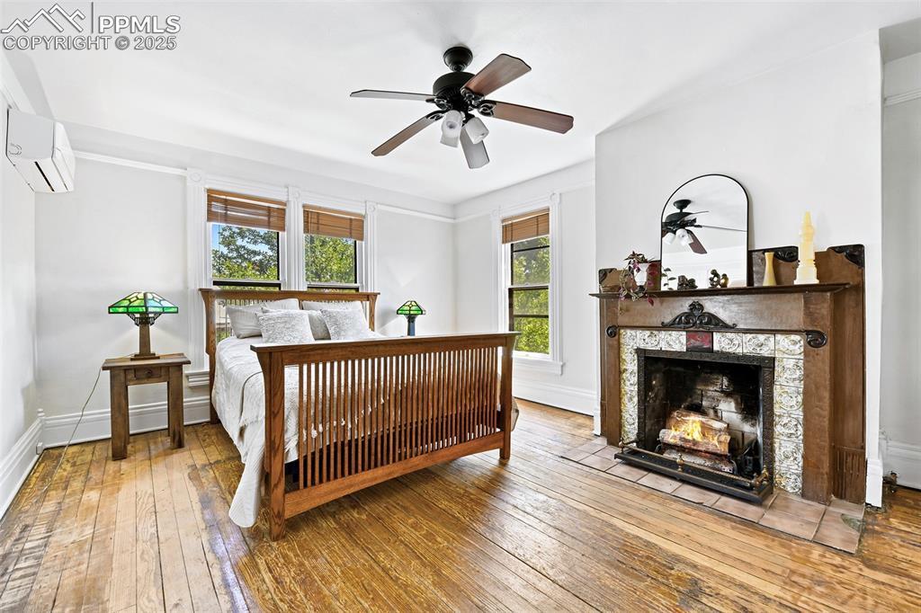Image 22 of 42: Head upstairs to the spacious Primary Bedroom with another gas fireplace!
