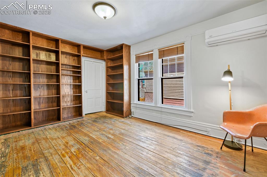Image 27 of 42: Across the hall sits a west-facing bedroom recently used as a library