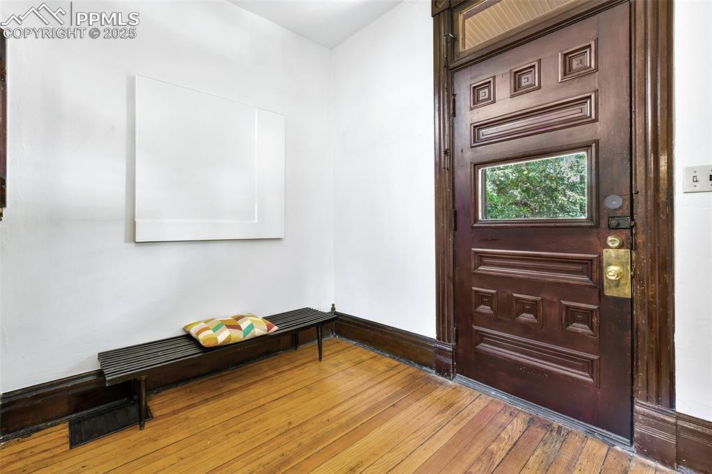 Image 4 of 42: Beautifully carved front-door opens into a roomy foyer