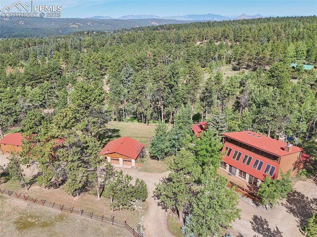 Image 2 of 49: View of main residence, garage, guest cabin, and barn
