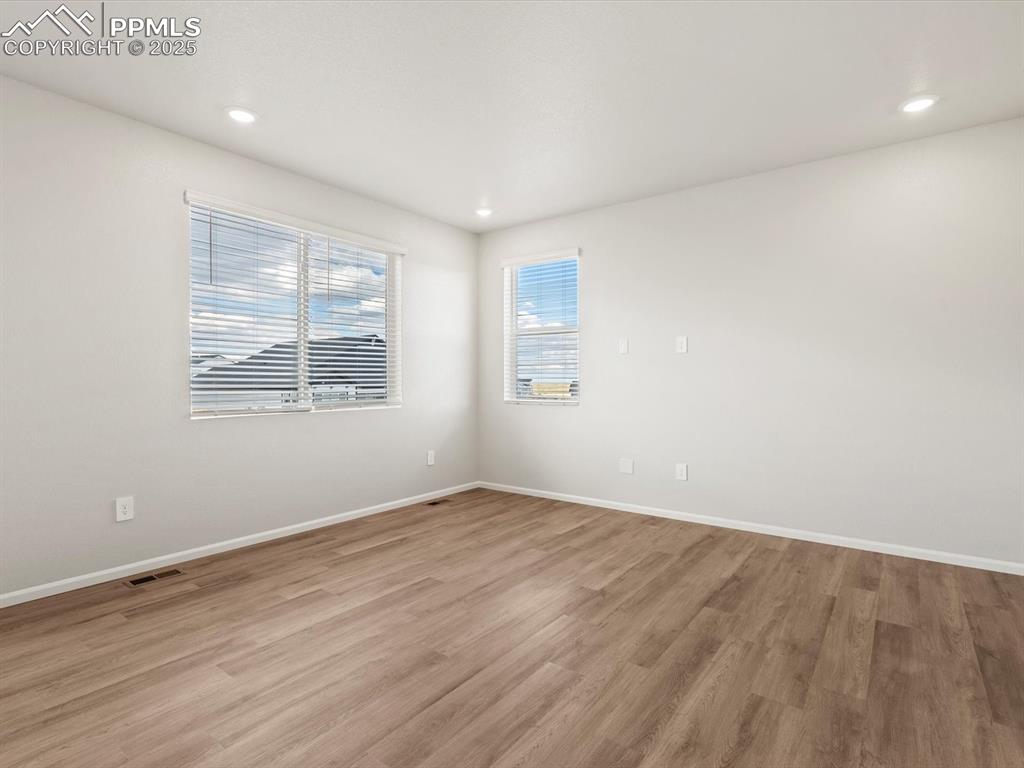 Image 14 of 24: Spare room with light wood-type flooring and recessed lighting