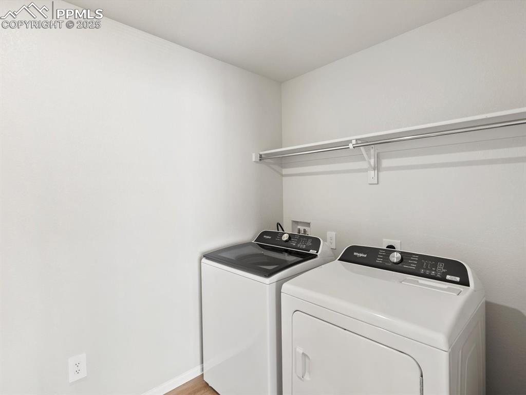 Image 15 of 24: Washroom featuring baseboards and independent washer and dryer