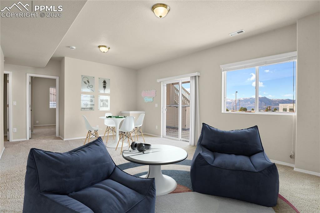 Image 20 of 41: Lower level family room with walk-out to extended patio. Virtually Stage