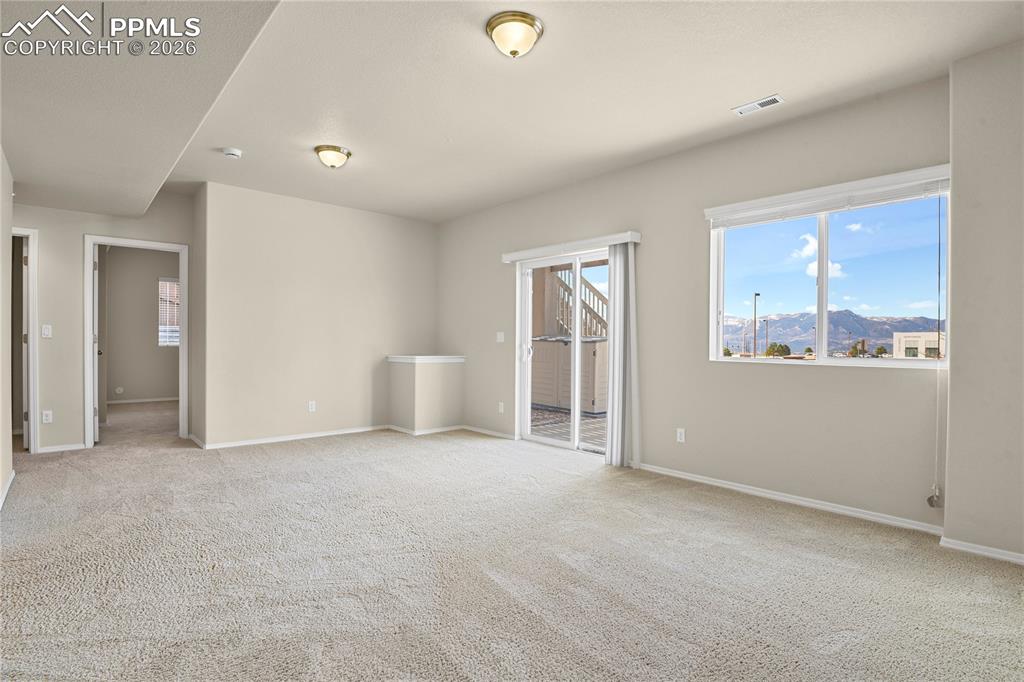 Image 36 of 41: Lower level family room with walk-out to extended patio.