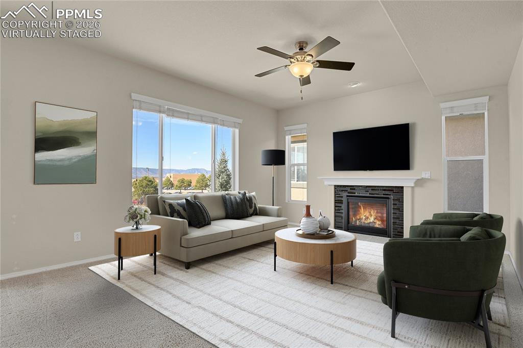 Image 9 of 41: Living room with gas fireplace. Virtually Staged