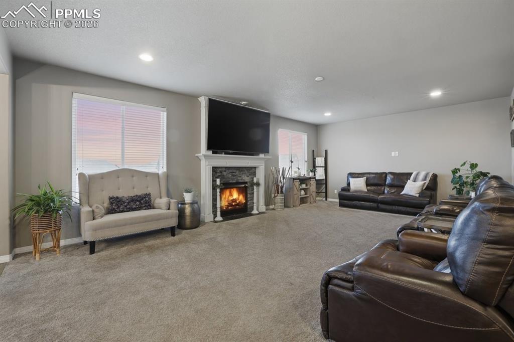 Image 18 of 49: spacious living room with cozy fireplace