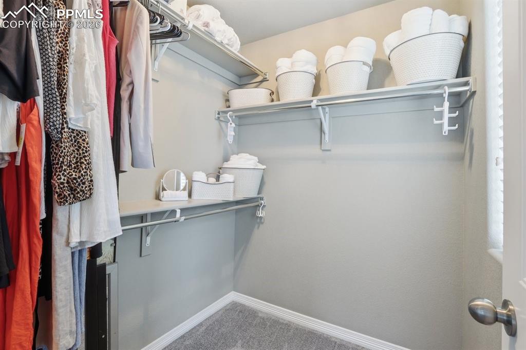 Image 35 of 49: bedroom walk-in closet with window
