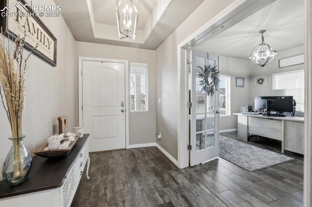 Image 5 of 49: entryway with bedroom/office to the left when you enter the home