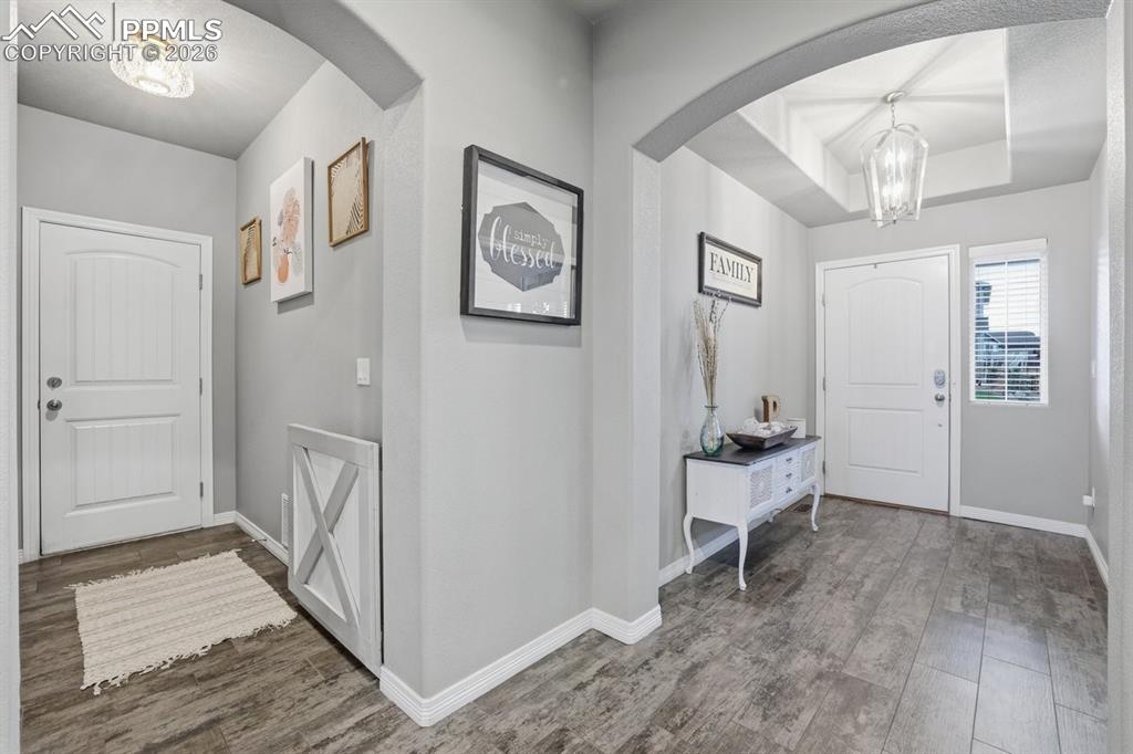 Image 6 of 49: front door and garage entry mudroom area