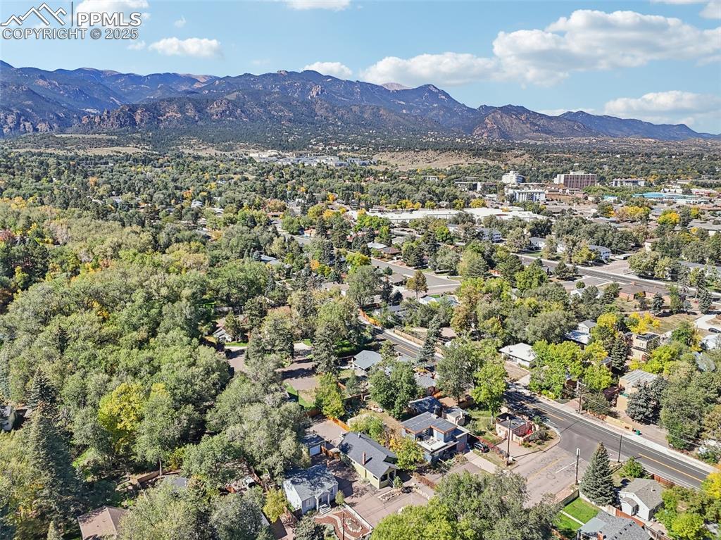Image 32 of 36: Aerial view of the home with Cheyenne mountain and pikes peak in the backgr