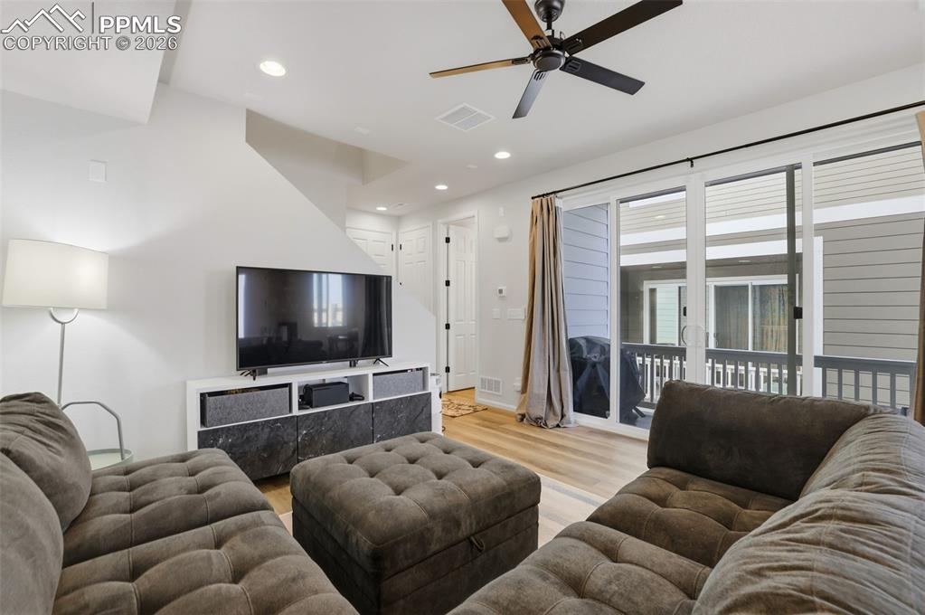 Image 14 of 31: Living area featuring recessed lighting, light wood-style floors, and a cei