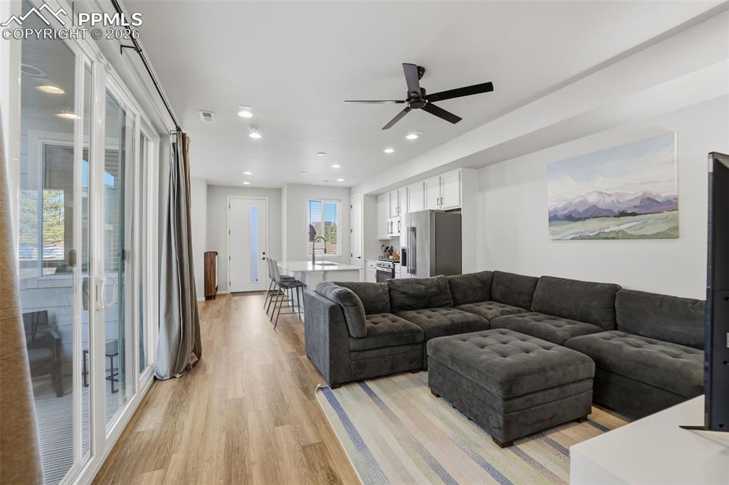 Image 15 of 31: Living area featuring light wood finished floors, recessed lighting, and a