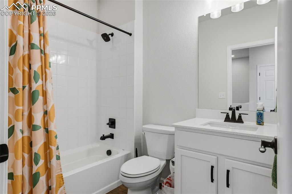 Image 20 of 31: Bathroom with vanity and shower / tub combo with curtain