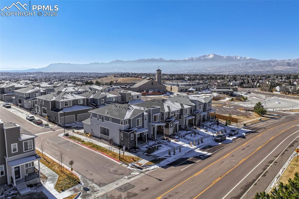 Image 3 of 31: Aerial perspective of suburban area with a mountain backdrop