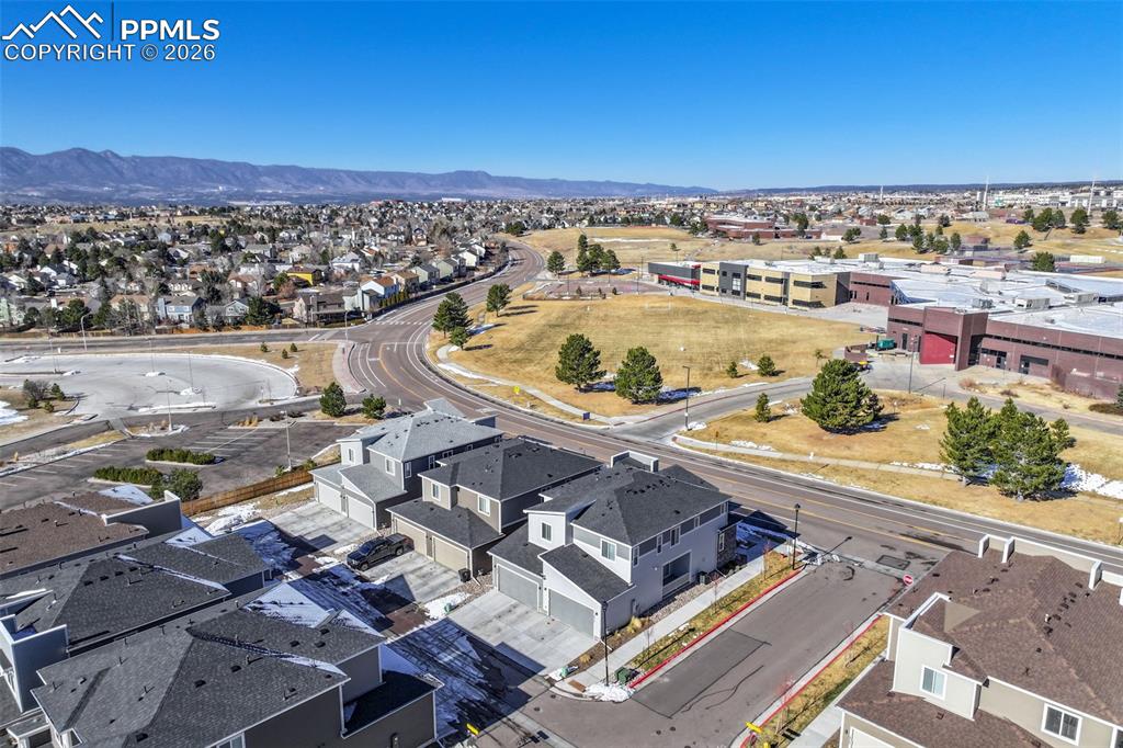 Image 5 of 31: Aerial view of residential area featuring a mountain backdrop
