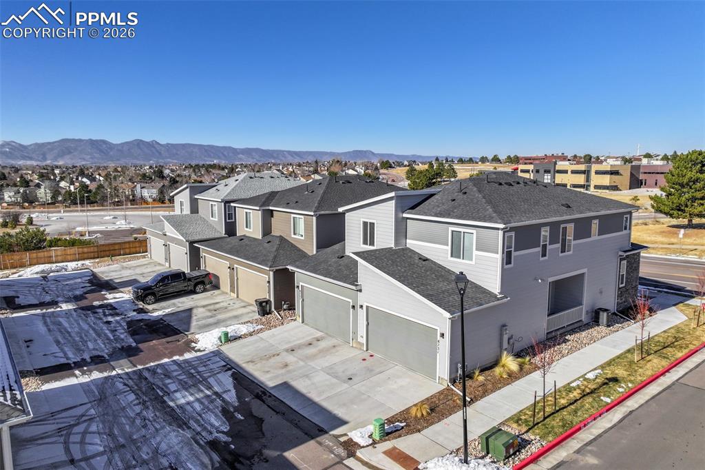 Image 6 of 31: Aerial view of residential area featuring mountains